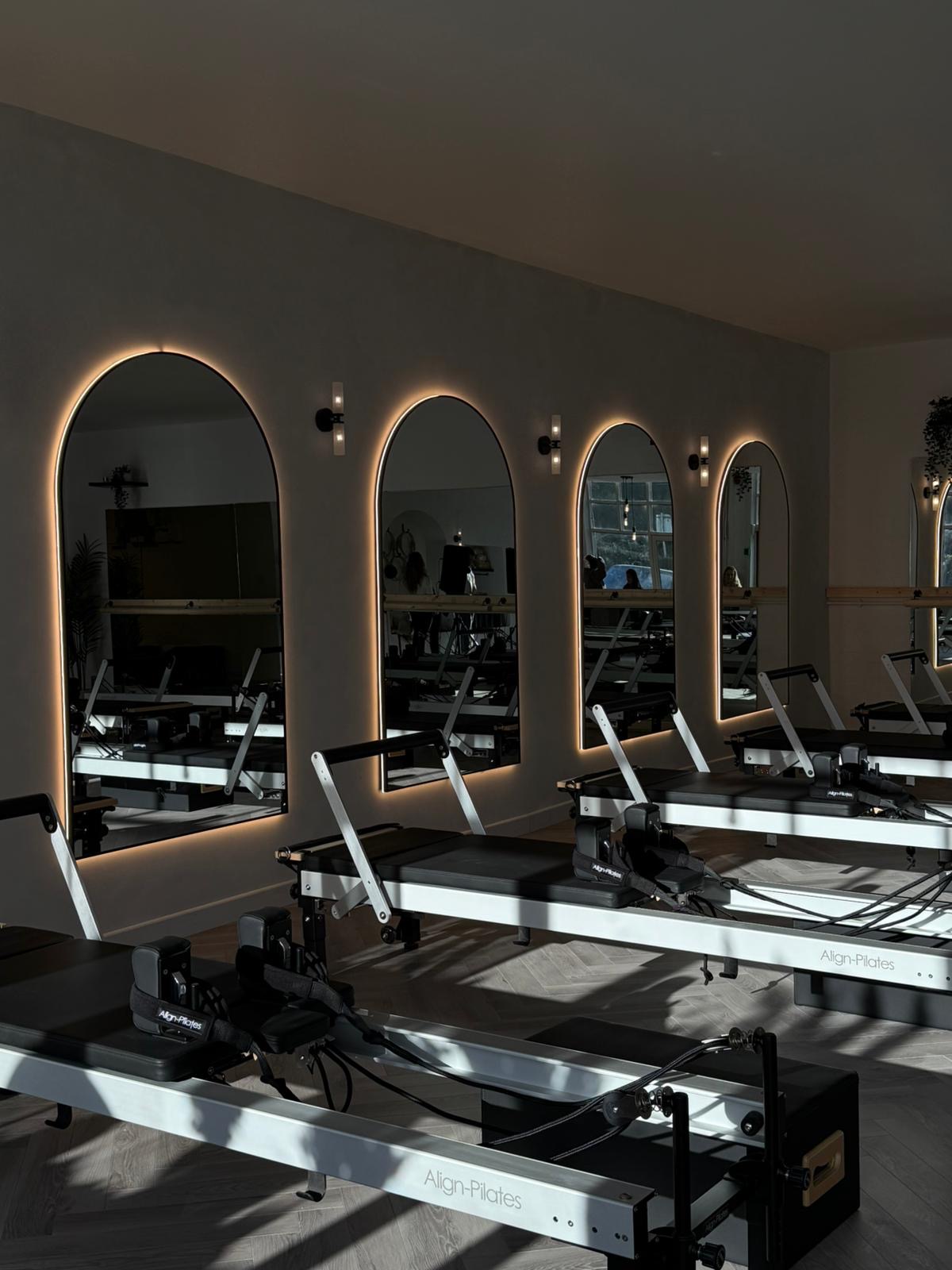 Completed Core by Ceri Pilates studio with illuminated mirrors and reformer equipment